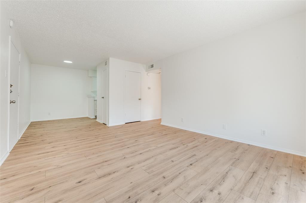 4859 Cedar Springs Road, Unit 337 Dallas, TX 75219 - Photo 8 of 20 a view of empty room with wooden floor