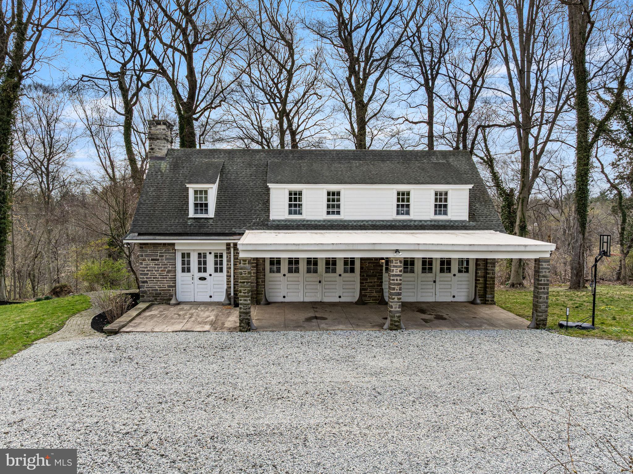 1018 Beech Road Wallingford, PA 19086 - Photo 54 of 66 a view of a house with a small yard and large trees