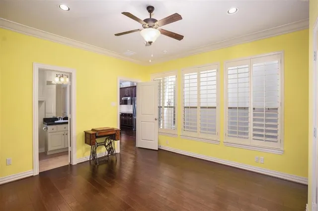 a room with pool table and wooden floor