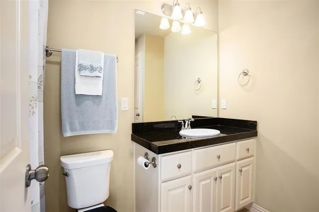 a bedroom with a bed couch and a large window