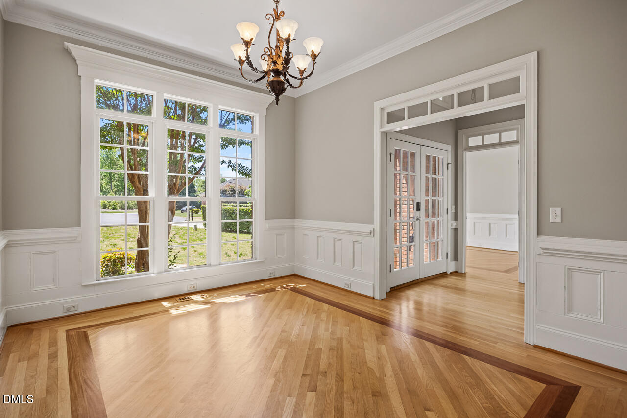 4004 Frontenac Court Apex, NC 27539 - Photo 7 of 61 a view of an empty room with wooden floor and a window
