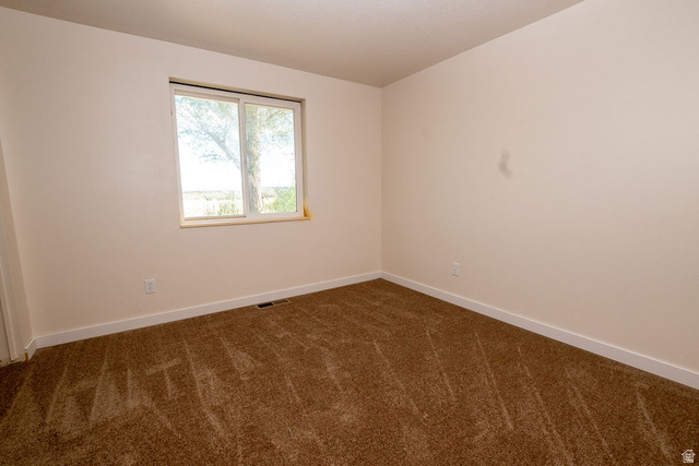 570 West Main Street Beaver, UT 84713 - Photo 19 of 43 Neutral-toned walls and brown carpet create a versatile interior