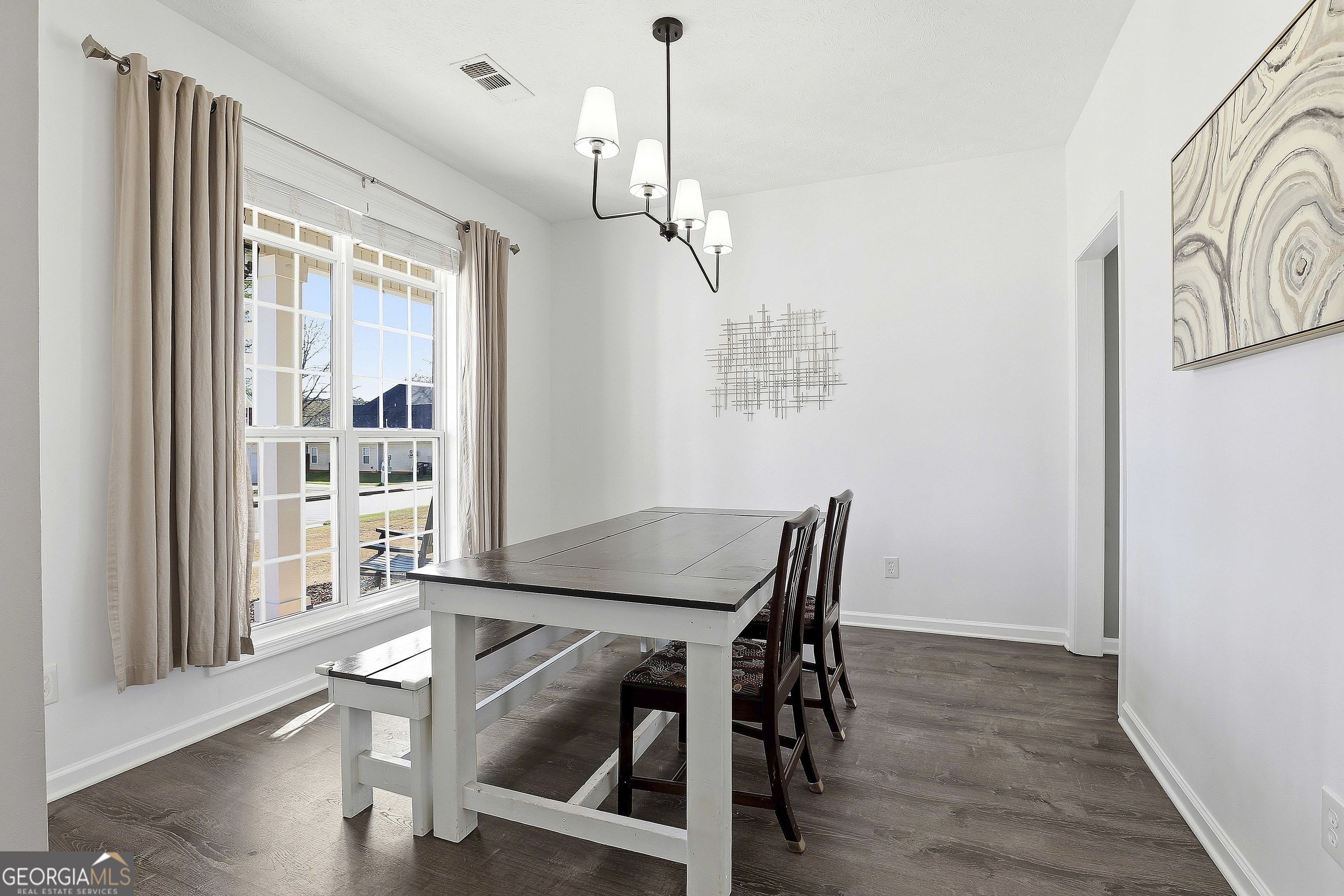 320 Emerald Way Senoia, GA 30276 - Photo 11 of 57 a view of a dining room with furniture window and wooden floor