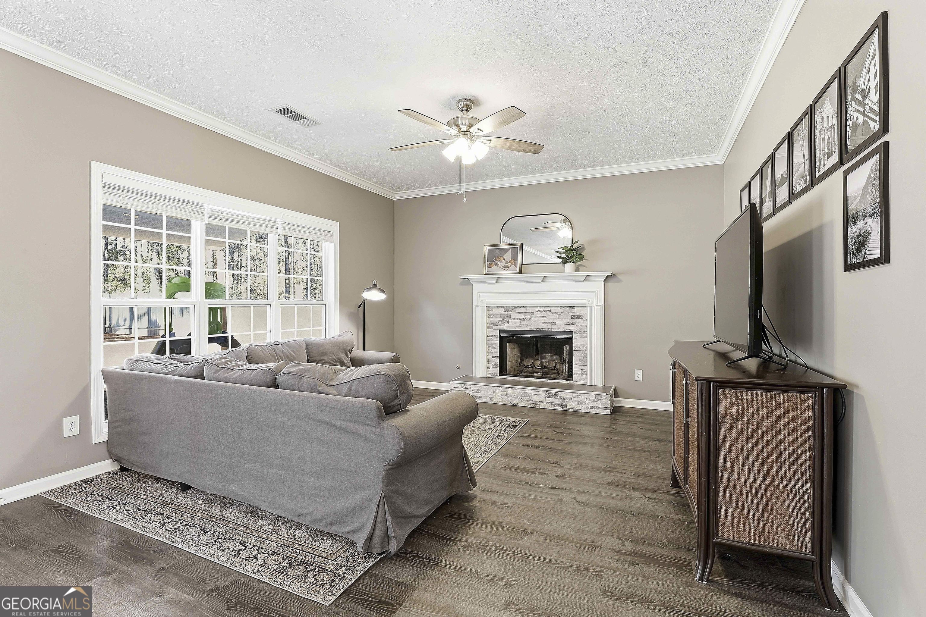 320 Emerald Way Senoia, GA 30276 - Photo 15 of 57 a living room with furniture a fireplace and a flat screen tv