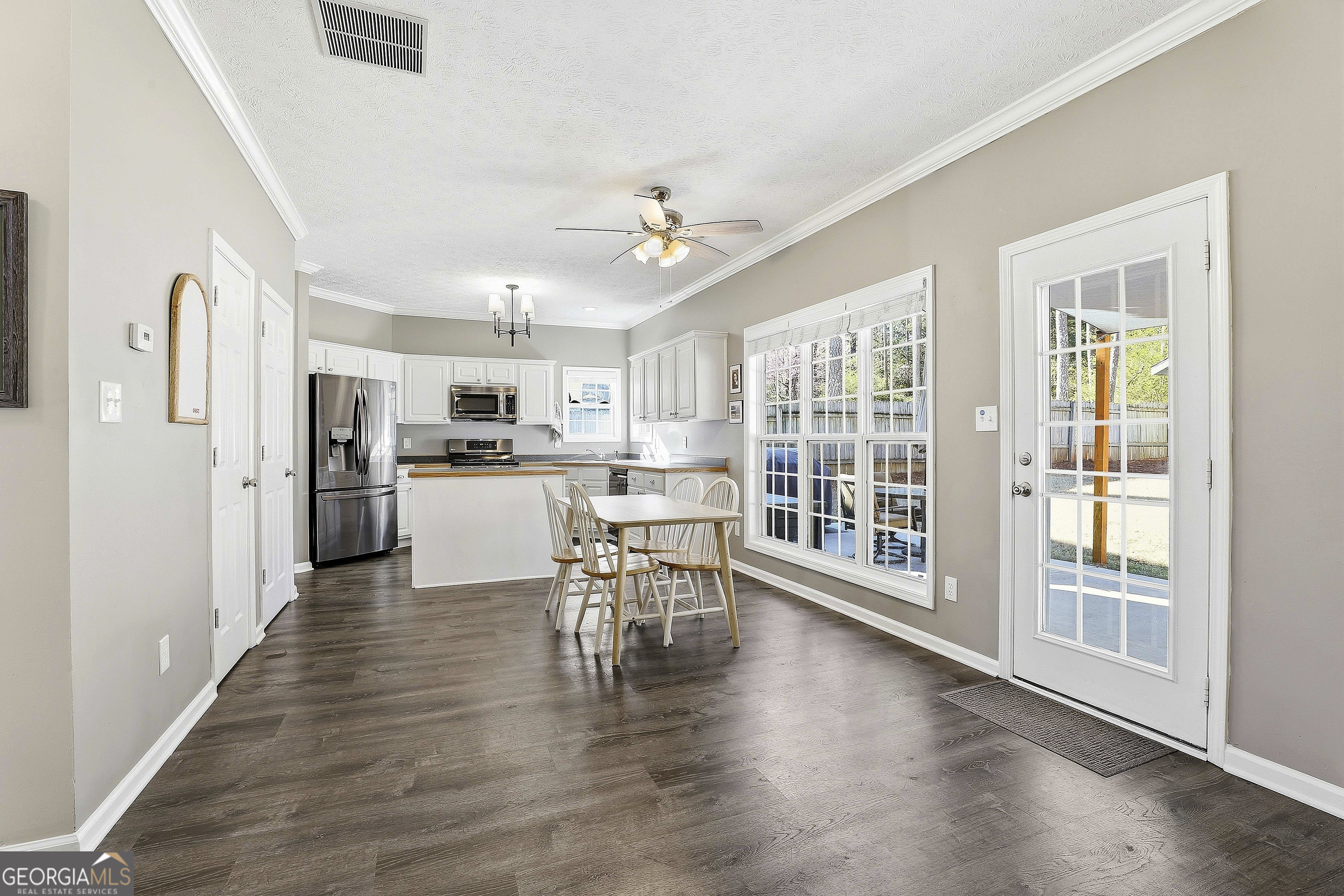 320 Emerald Way Senoia, GA 30276 - Photo 20 of 57 a view of a kitchen with furniture wooden floor and a kitchen