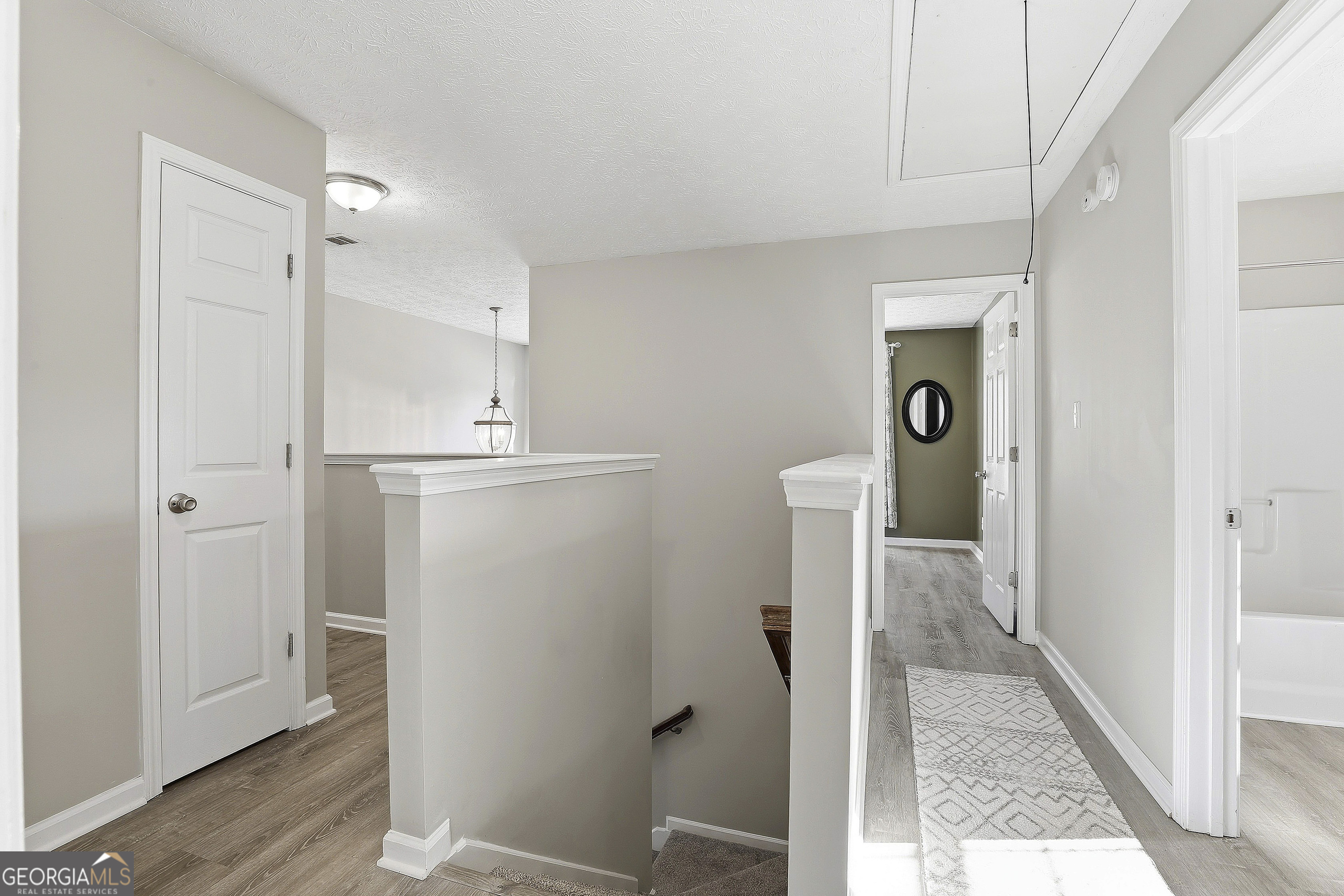 320 Emerald Way Senoia, GA 30276 - Photo 28 of 57 a view of a hallway with wooden floor and cabinet
