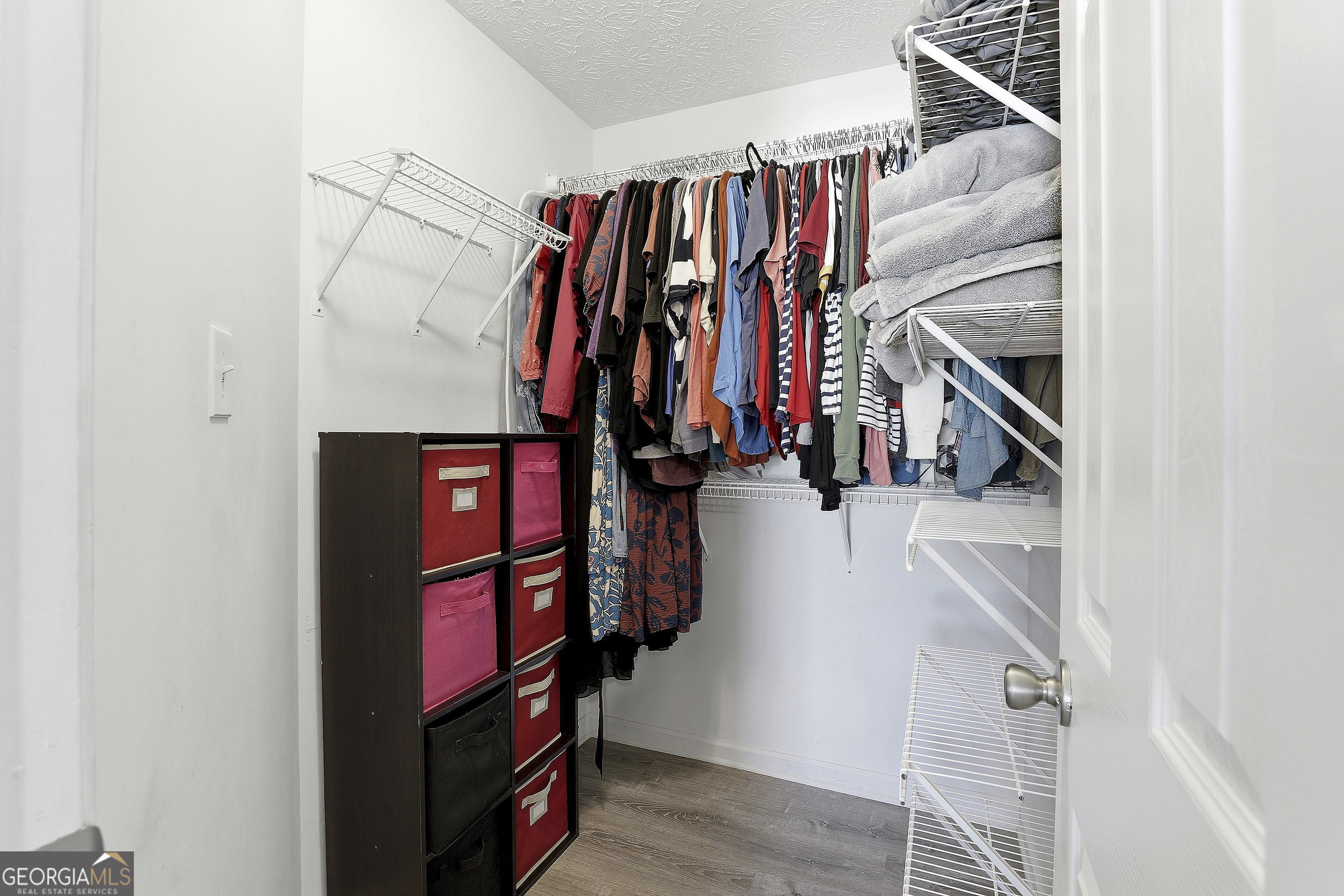 320 Emerald Way Senoia, GA 30276 - Photo 34 of 57 a view of walk in closet with clothes and shoes