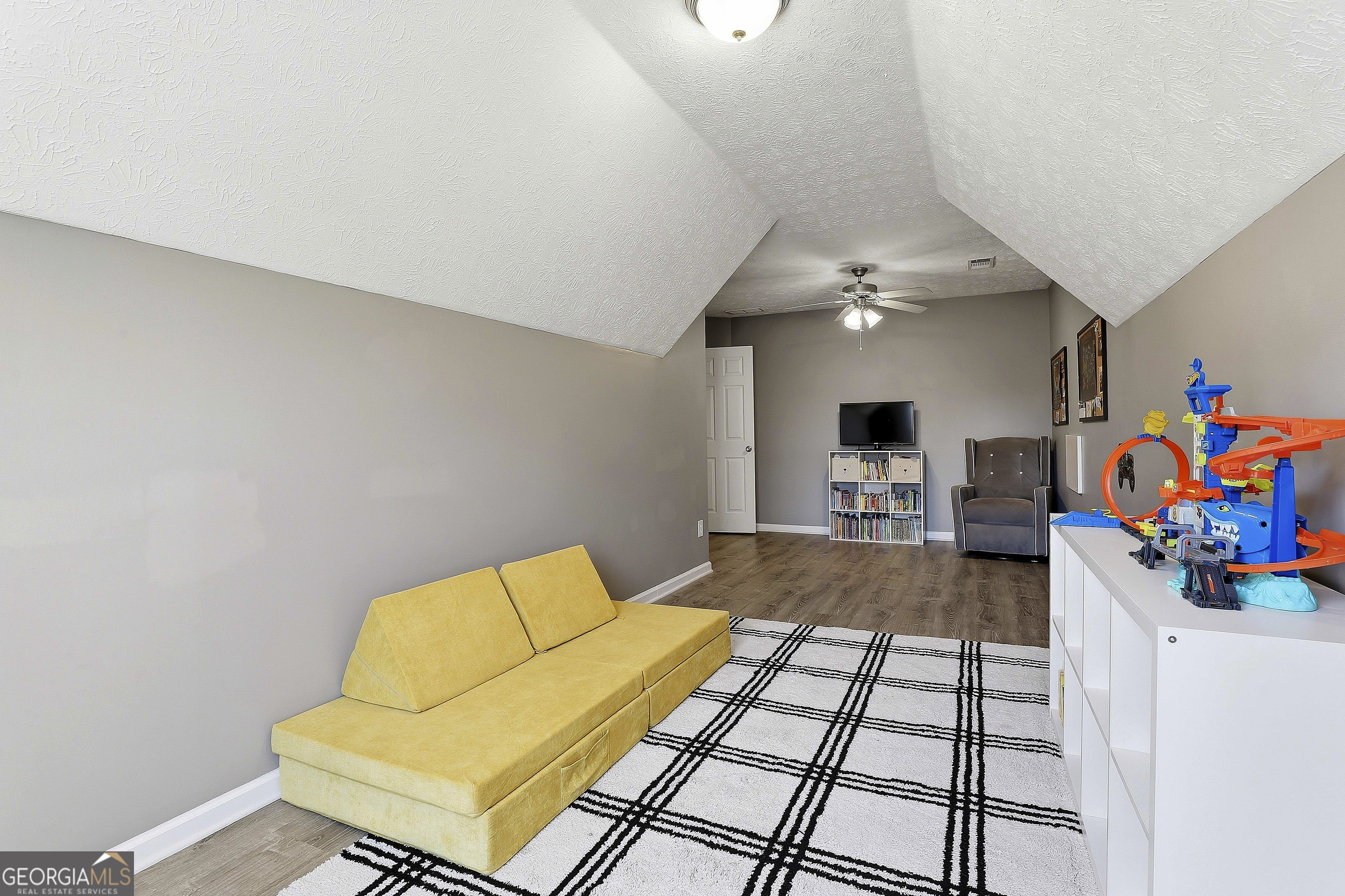 320 Emerald Way Senoia, GA 30276 - Photo 40 of 57 a living room with furniture and a flat screen tv