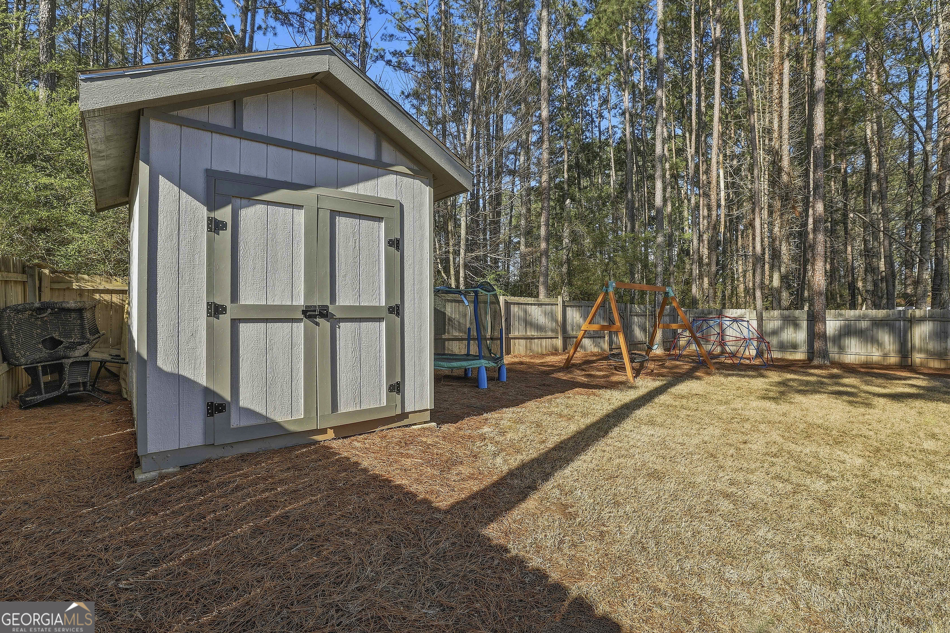 320 Emerald Way Senoia, GA 30276 - Photo 48 of 57 a view of a backyard with wooden fence