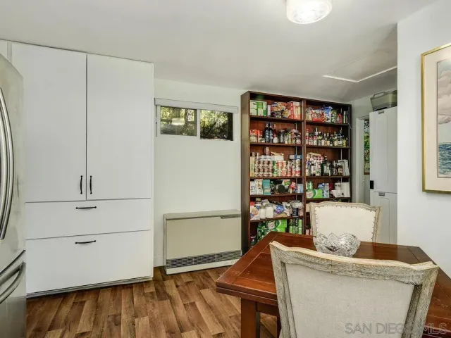 a room with a book shelf and a wooden floor