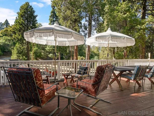 a view of a patio with a table and chairs under an umbrella