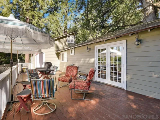 a view of a chairs and tables in the patio in front of a house