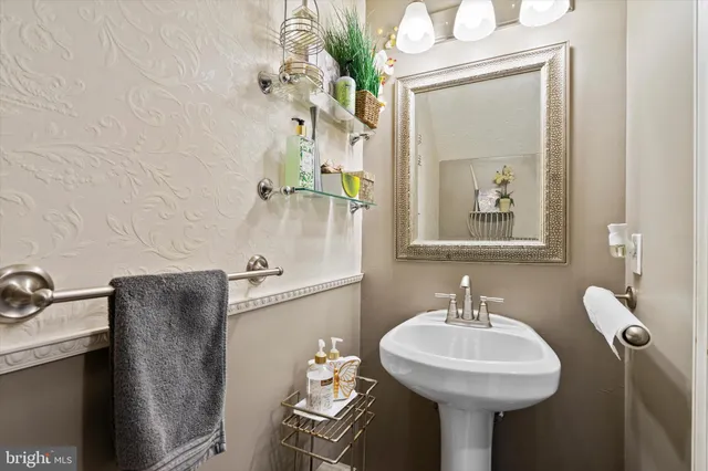 a bathroom with a sink a mirror and a toilet