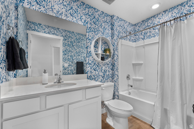 722 West 2840 South, Unit 8 Logan, UT 84321 - Photo 18 of 23 Bathroom featuring vanity, shower / bathtub combination with curtain, light wood finished floors, and wallpapered walls