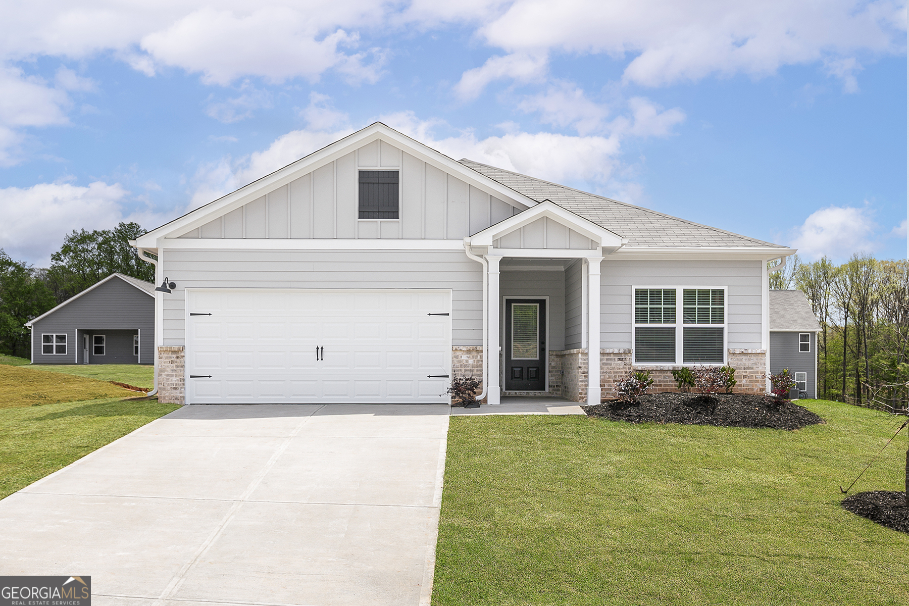 a front view of a house with a yard and porch