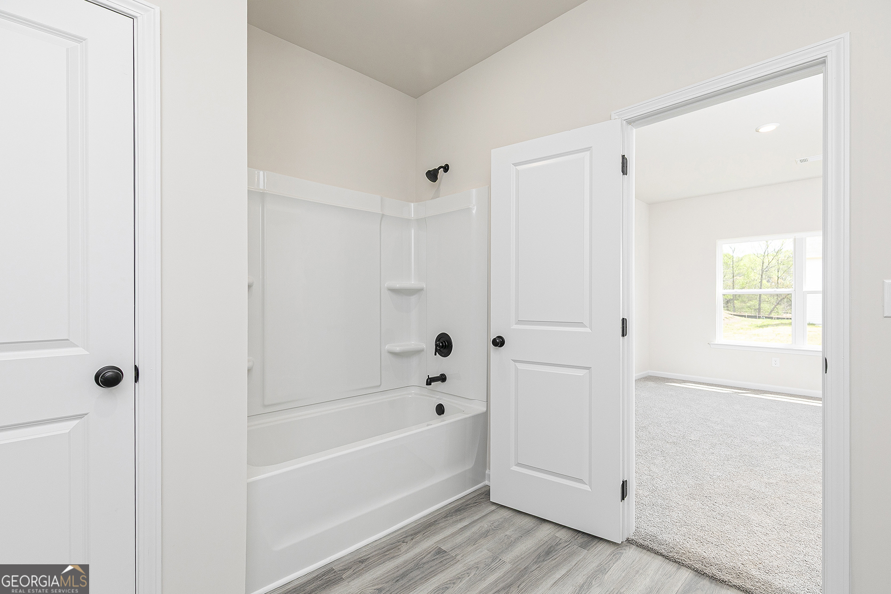 217 Darter Court Hoschton, GA 30548 - Photo 15 of 23 a bathroom with a bathtub and a shower