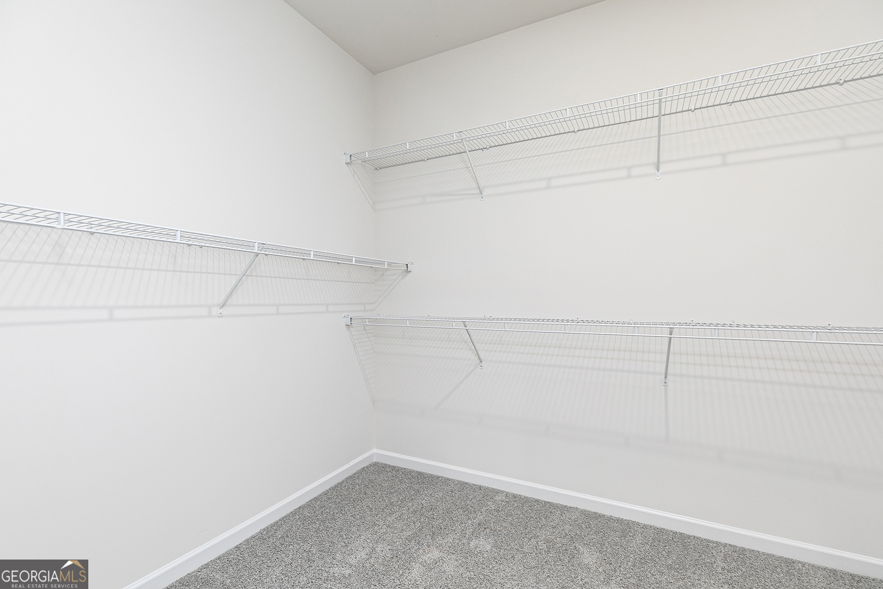 217 Darter Court Hoschton, GA 30548 - Photo 16 of 23 a view of a room with racks on the wall