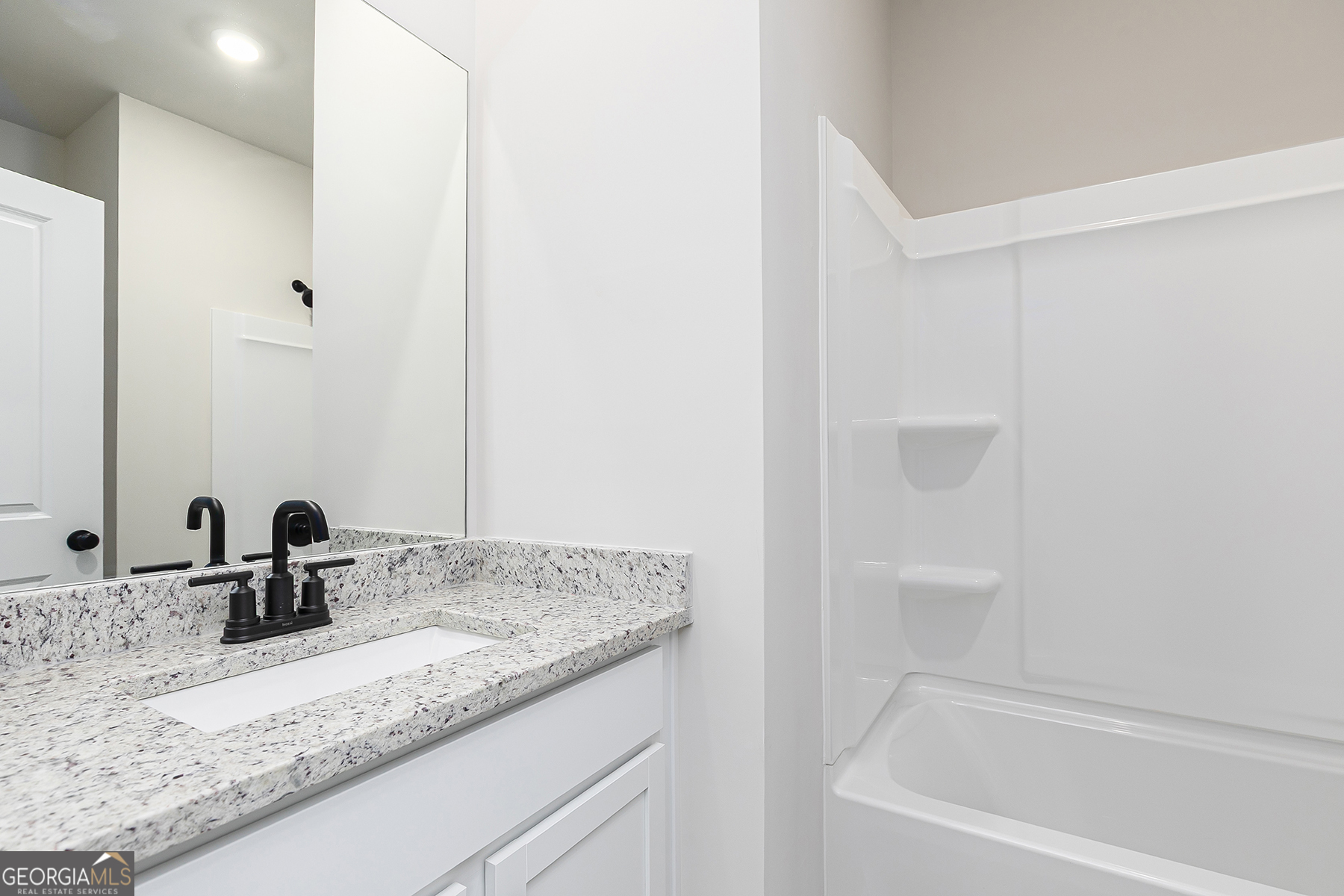 217 Darter Court Hoschton, GA 30548 - Photo 19 of 23 a bathroom with a granite countertop sink and a mirror