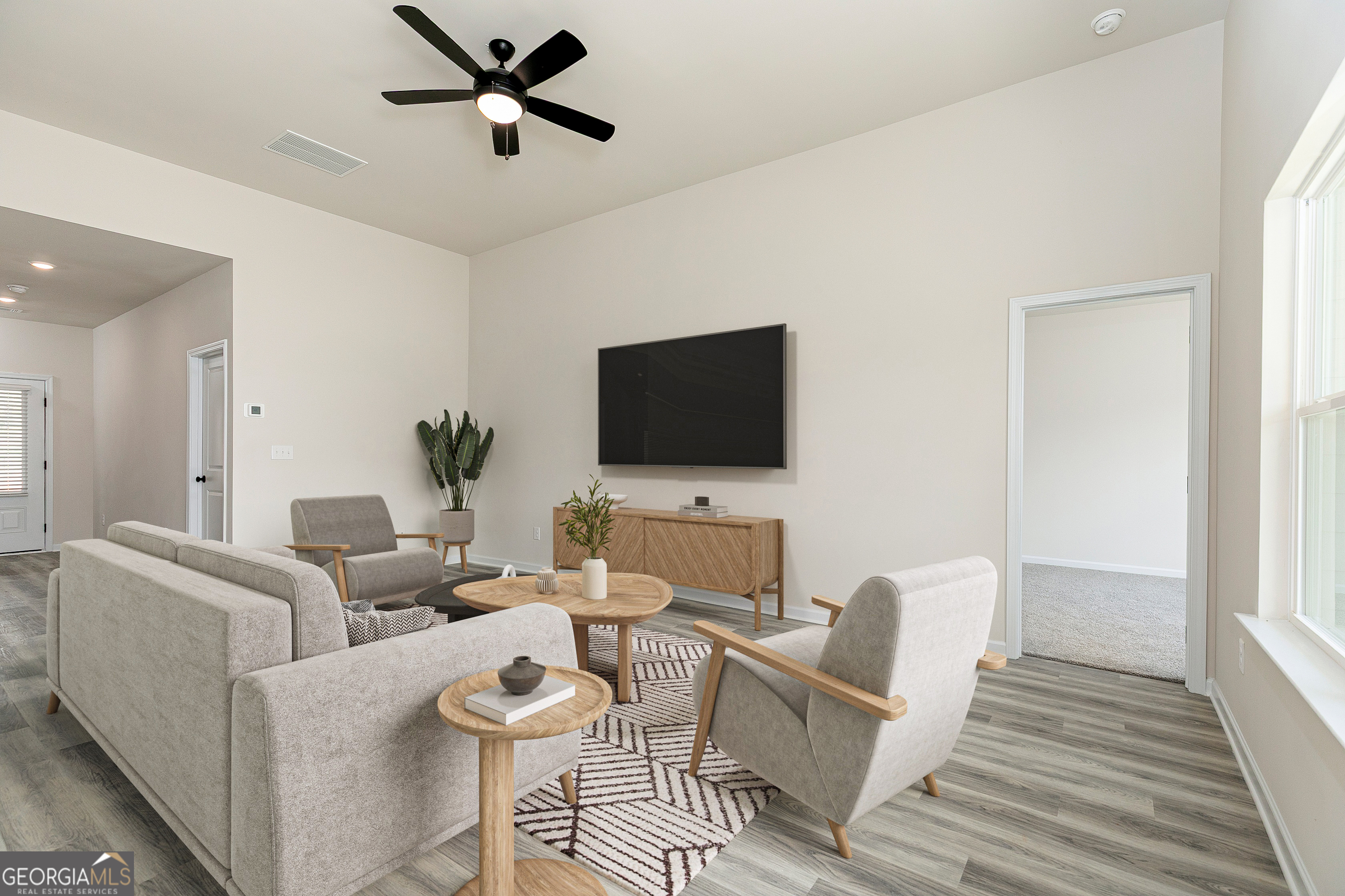 217 Darter Court Hoschton, GA 30548 - Photo 20 of 23 a living room with furniture and a flat screen tv