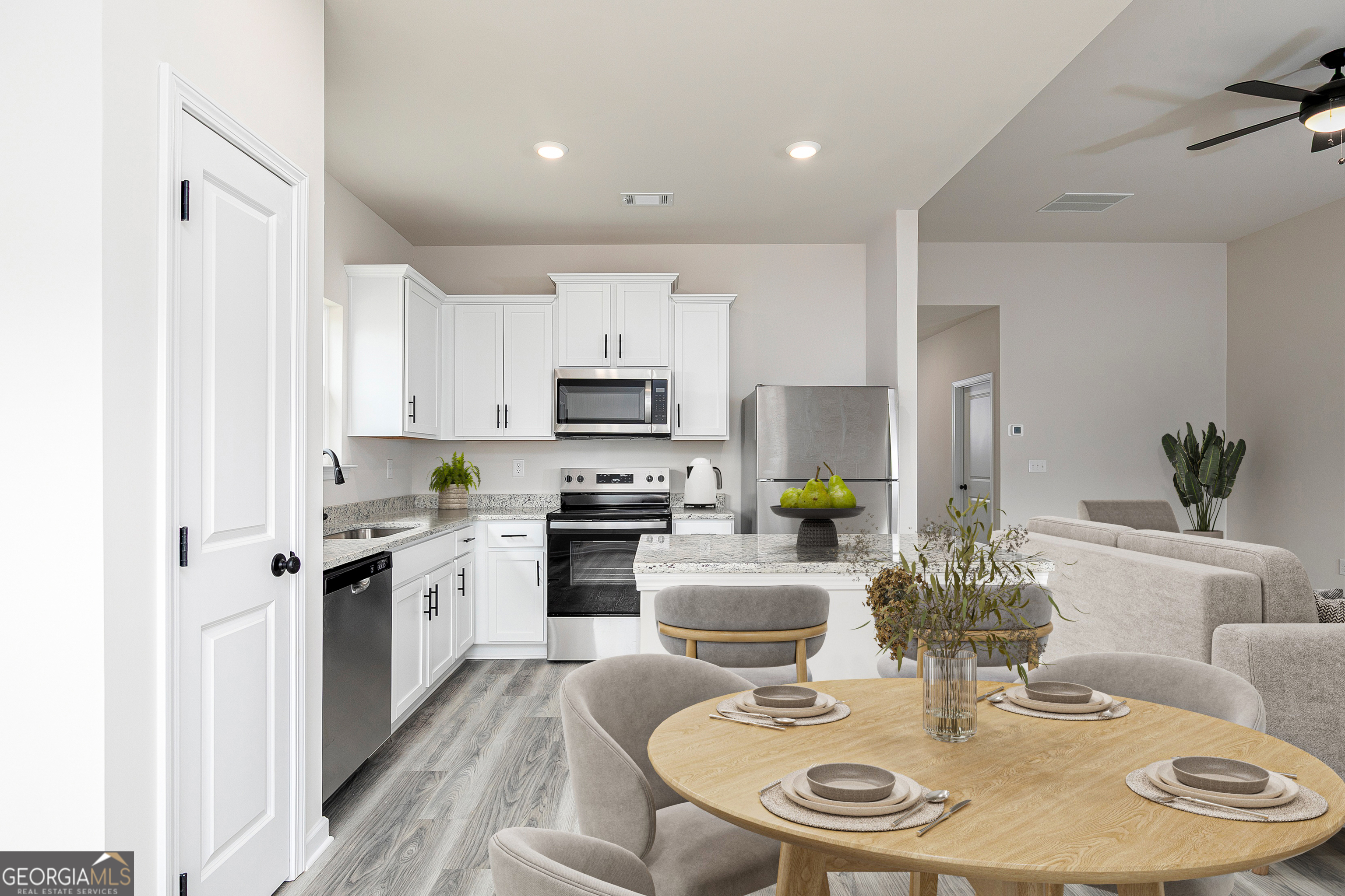 217 Darter Court Hoschton, GA 30548 - Photo 21 of 23 a kitchen with sink stove and white cabinets