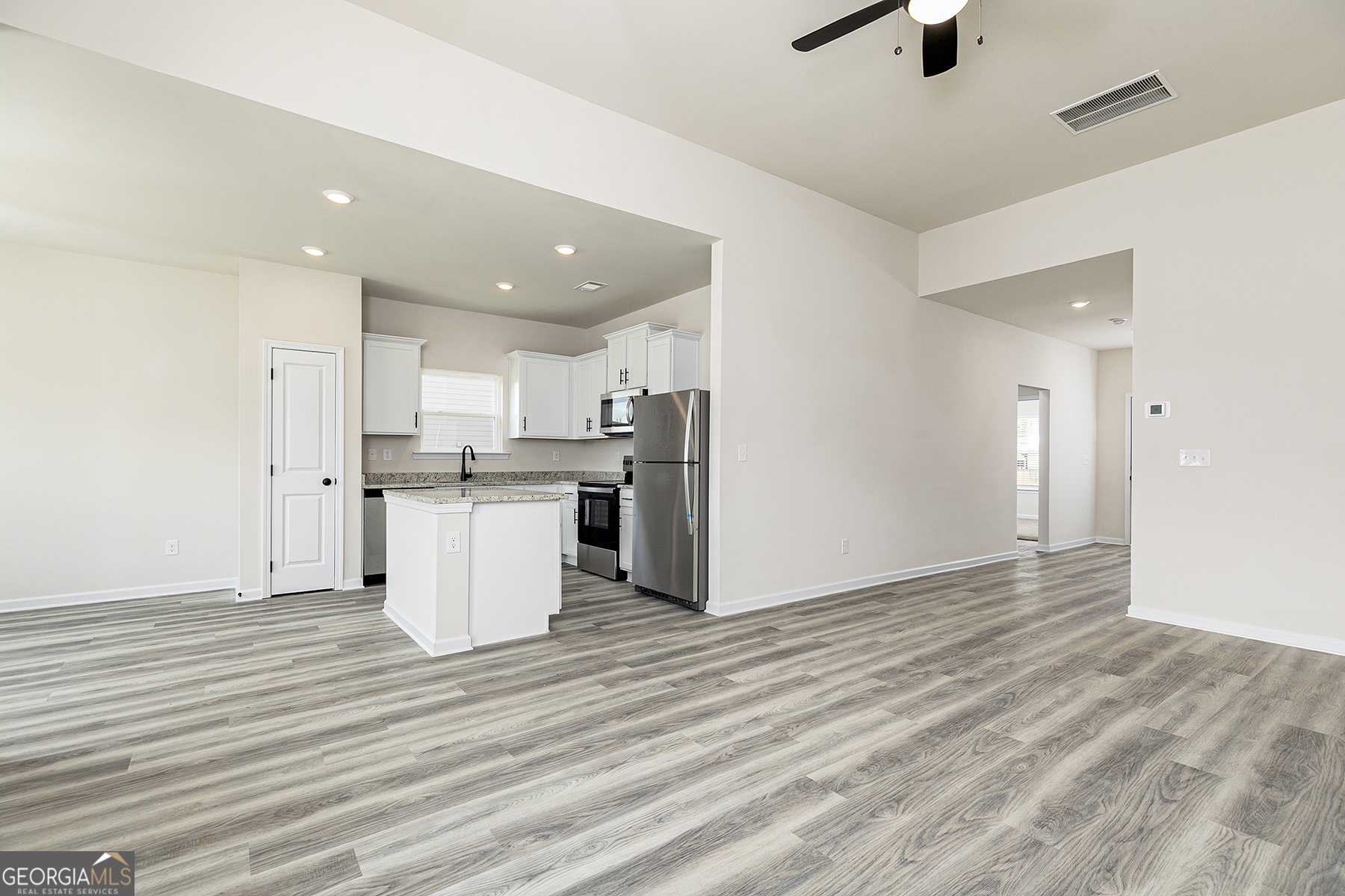 217 Darter Court Hoschton, GA 30548 - Photo 6 of 23 a view of kitchen view wooden cabinets and window