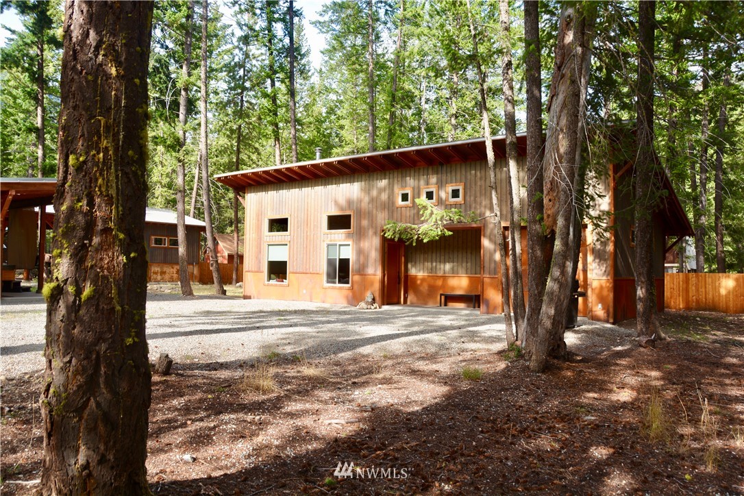 a view of a house with a tree in front of it