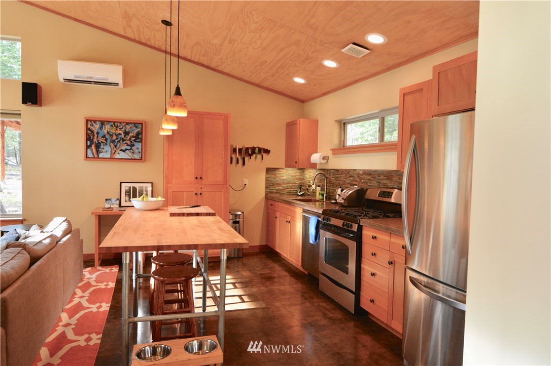 16 Littell Road Mazama, WA 98833 - Photo 5 of 21 a kitchen with stainless steel appliances granite countertop a sink a stove and a refrigerator