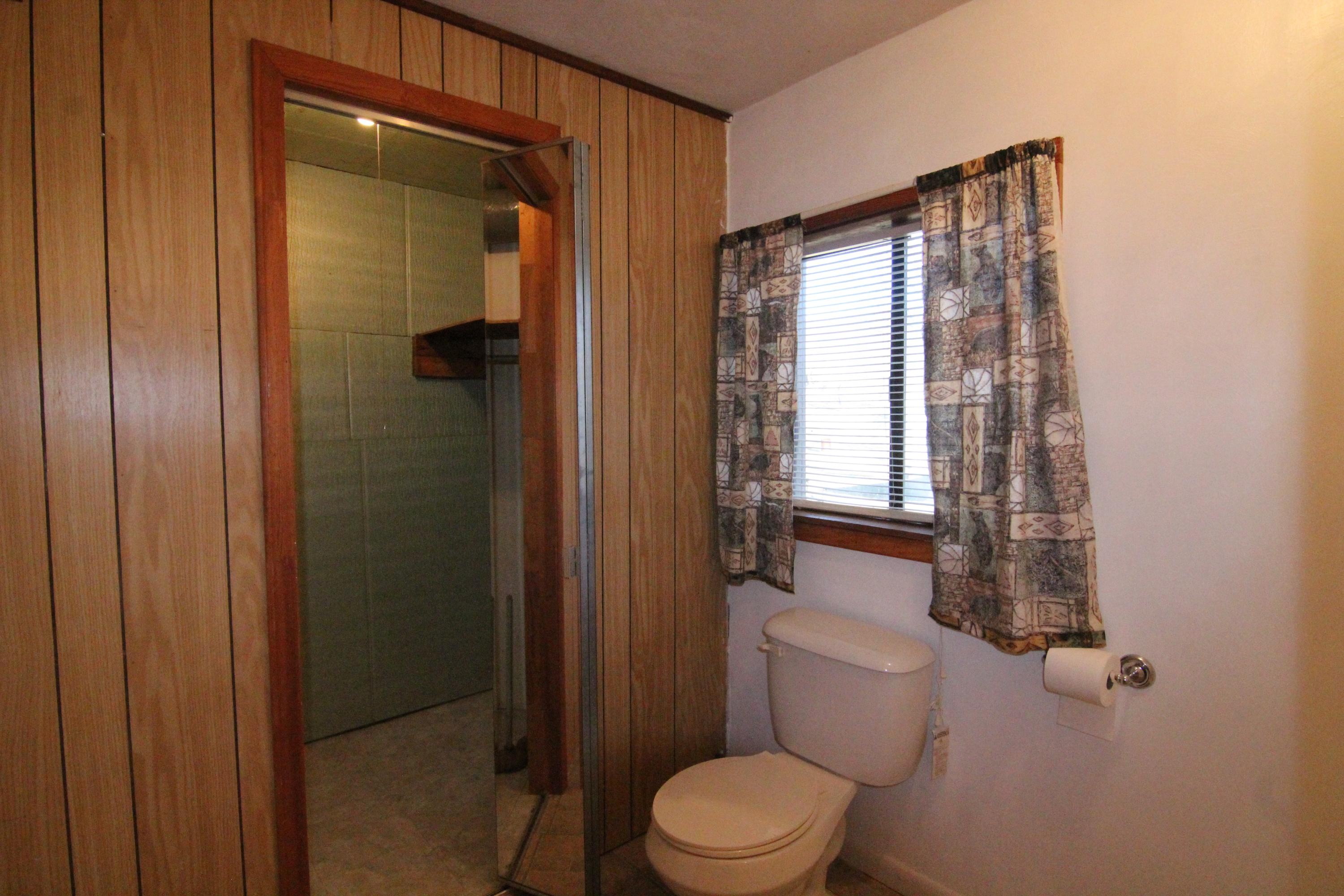 252 Colonial Road Blue Ridge, VA 24064 - Photo 22 of 30 a bathroom with a toilet a sink and shower