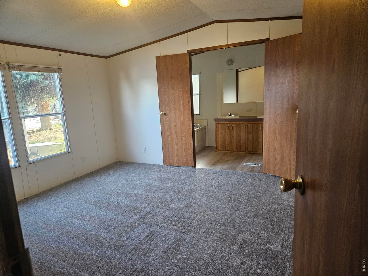 230 North 2nd Street, Unit 59 Berthoud, CO 80513 - Photo 7 of 19 an empty room with mirror and a bathroom