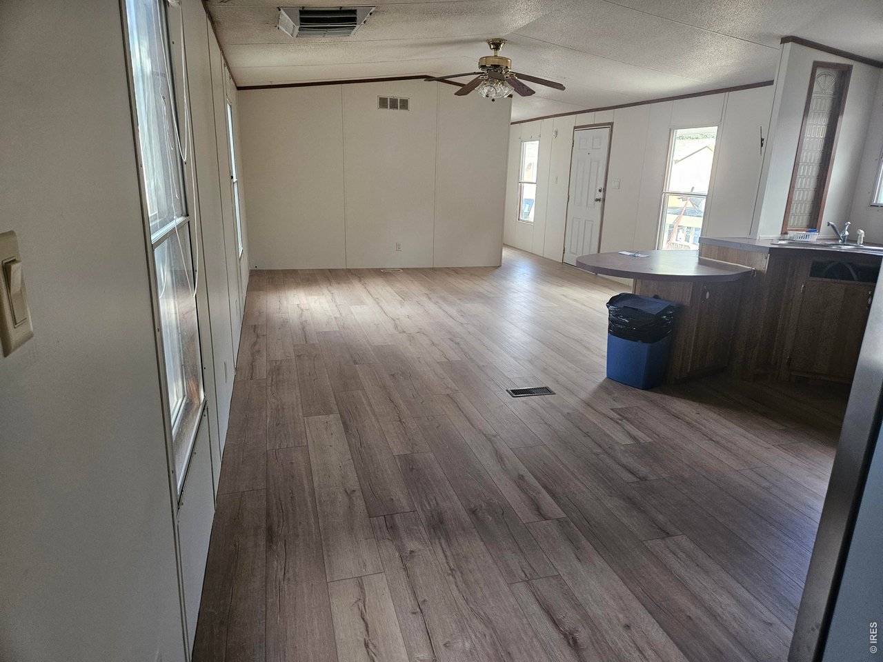 230 North 2nd Street, Unit 59 Berthoud, CO 80513 - Photo 8 of 19 wooden floor in an empty room with a mirror