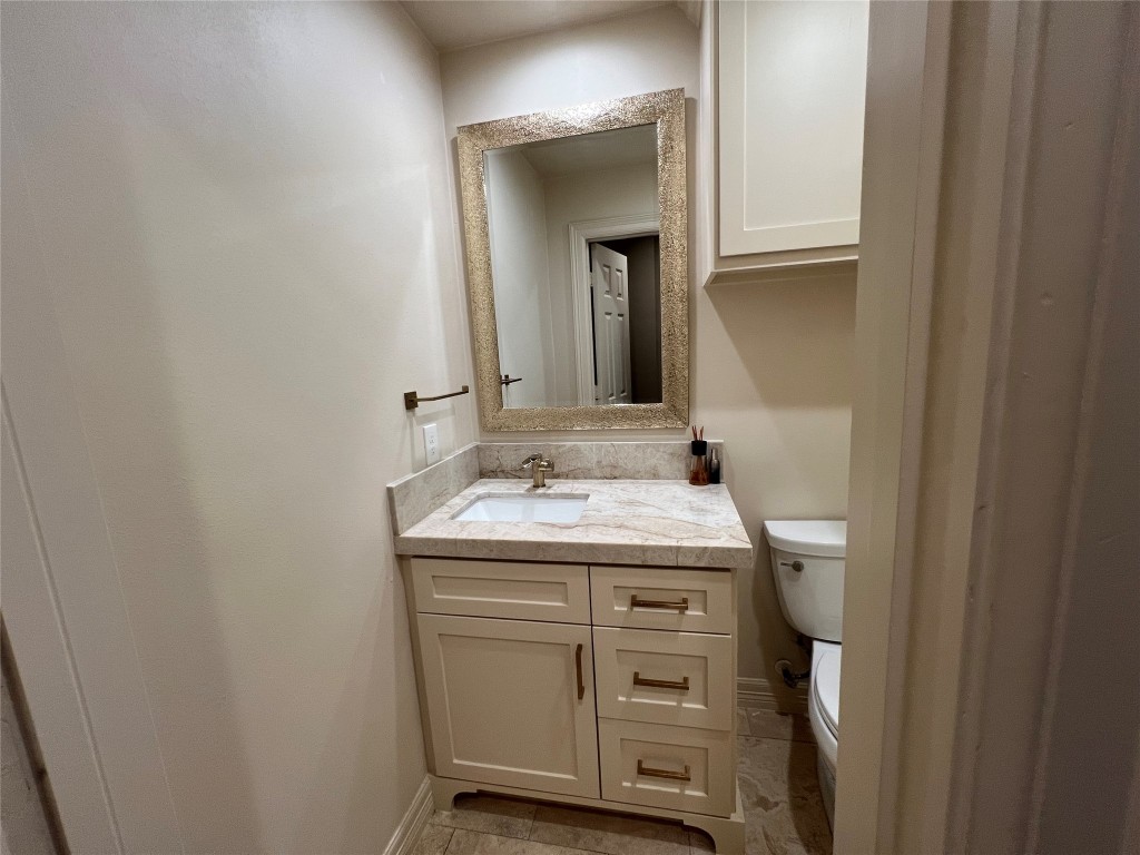 1014 Roxella Street Houston, TX 77076 - Photo 14 of 30 a bathroom with a granite countertop sink and a mirror