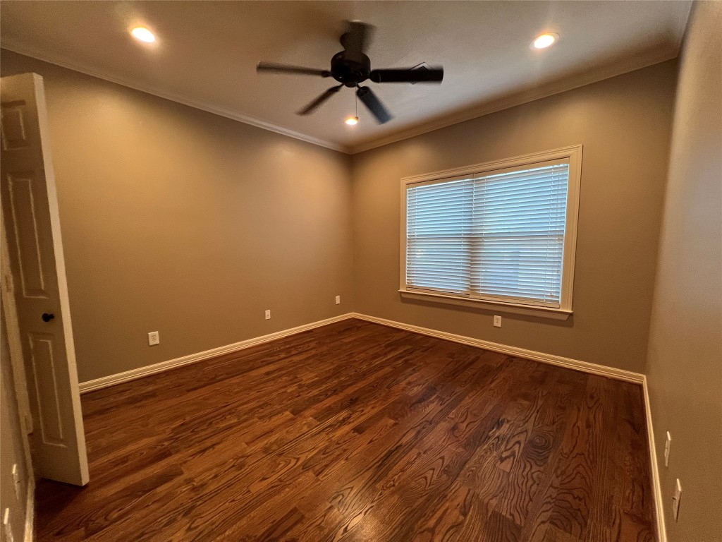 1014 Roxella Street Houston, TX 77076 - Photo 22 of 30 a view of empty room with wooden floor and fan