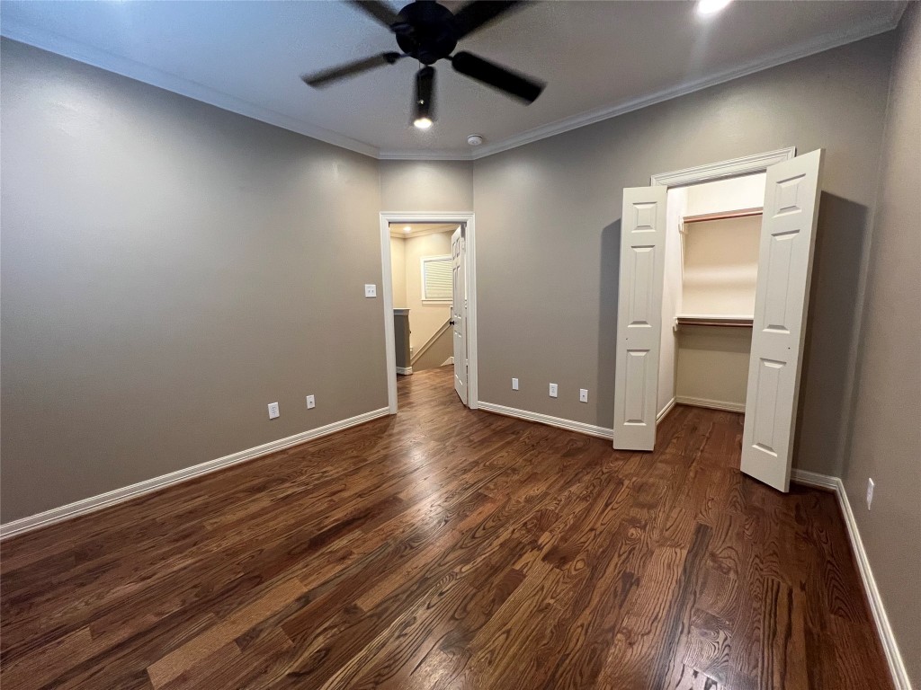 1014 Roxella Street Houston, TX 77076 - Photo 23 of 30 an empty room with wooden floor and a ceiling fan