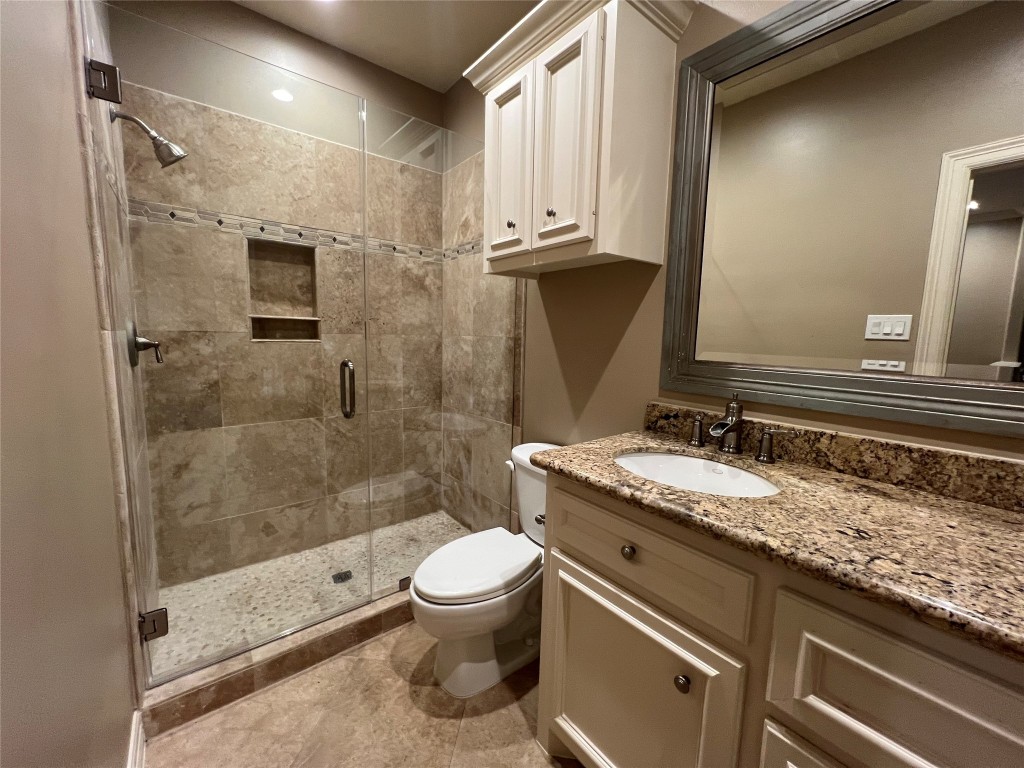 1014 Roxella Street Houston, TX 77076 - Photo 25 of 30 a bathroom with a granite countertop sink a toilet and shower