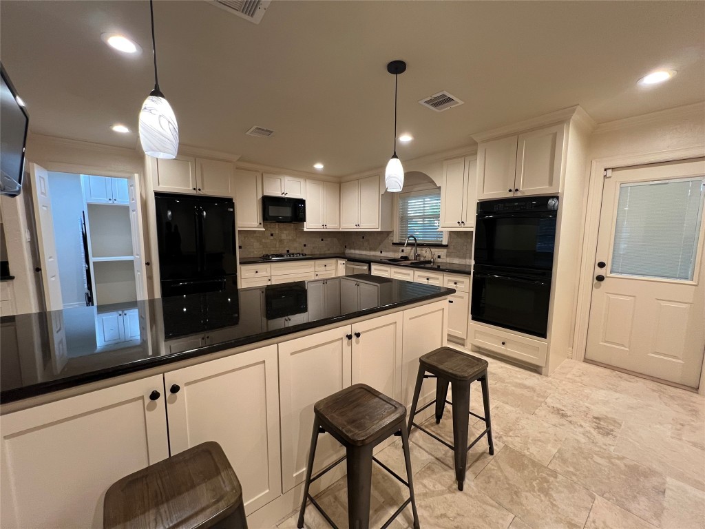 1014 Roxella Street Houston, TX 77076 - Photo 8 of 30 a kitchen with stainless steel appliances a refrigerator sink and microwave