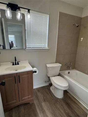 a bathroom with a sink toilet a mirror and bathtub