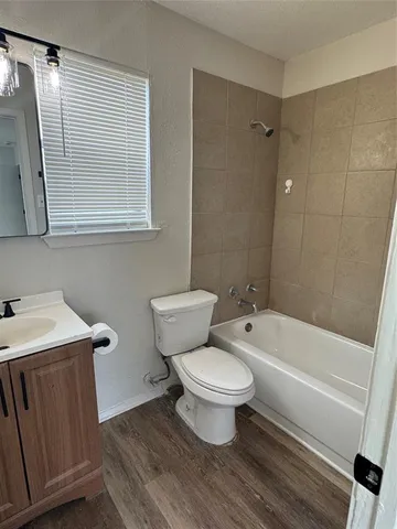 a bathroom with a sink toilet a mirror and shower