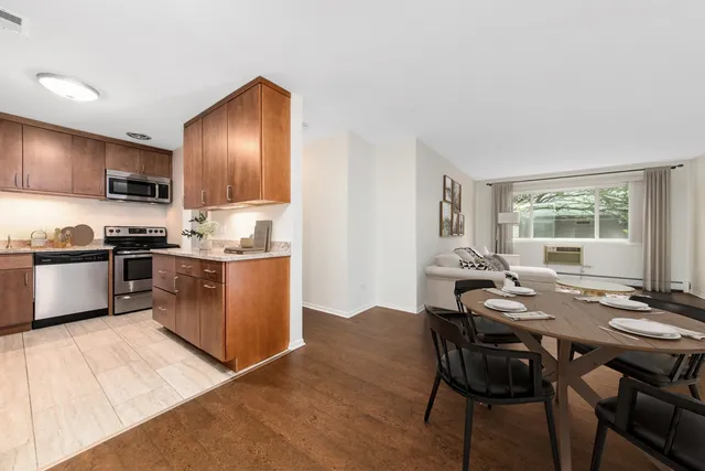 a kitchen with kitchen island granite countertop a sink counter and chairs