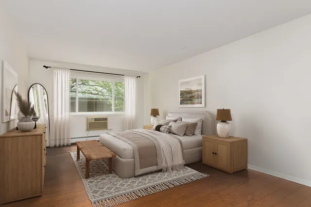 a bedroom with bed and a window