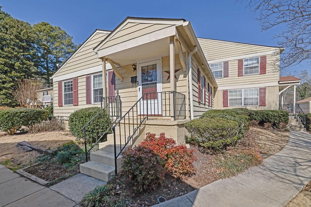 1358 Old Coach Road Southwest Marietta, GA 30008 - Photo 1 of 1 a view of a house with a small yard plants and large tree