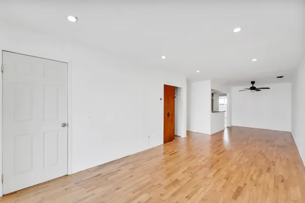 a view of an empty room with wooden floor