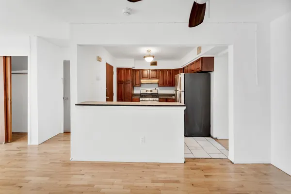 a view of kitchen with refrigerator and microwave