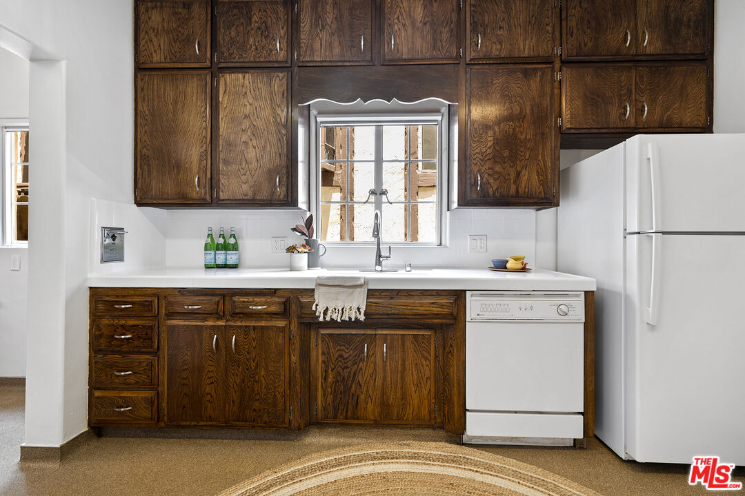 5473 Dahlia Drive Los Angeles, CA 90041 - Photo 14 of 34 a kitchen with a refrigerator and a sink