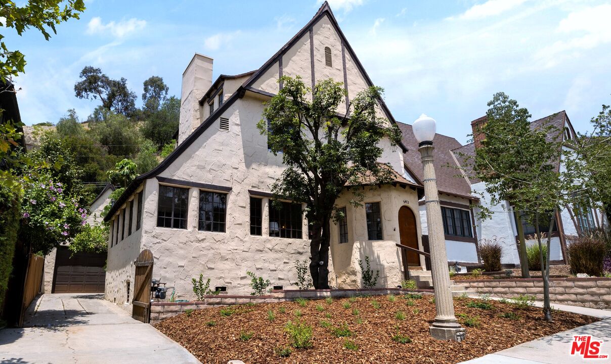 5473 Dahlia Drive Los Angeles, CA 90041 - Photo 2 of 34 a view of a white house with a yard