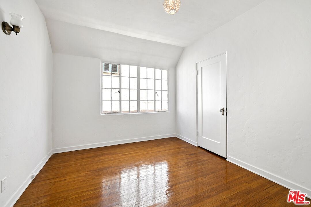 5473 Dahlia Drive Los Angeles, CA 90041 - Photo 25 of 34 an empty room with wooden floor and windows