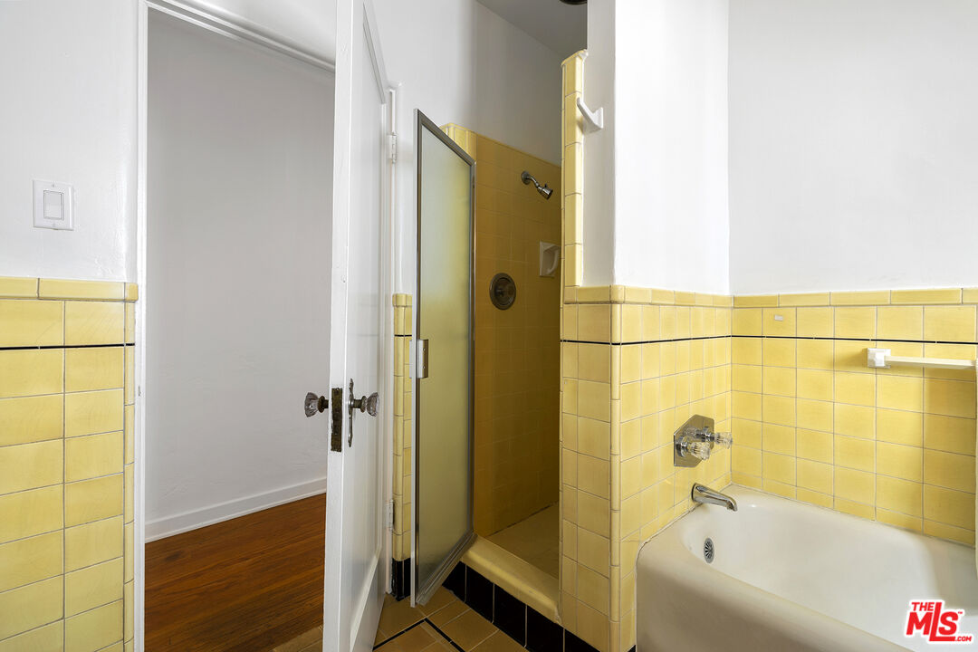 5473 Dahlia Drive Los Angeles, CA 90041 - Photo 28 of 34 a bathroom with a bathtub and a shower