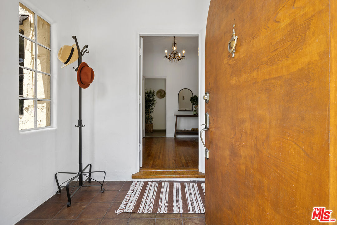 5473 Dahlia Drive Los Angeles, CA 90041 - Photo 3 of 34 a view of a hallway with wooden floor and a potted plant