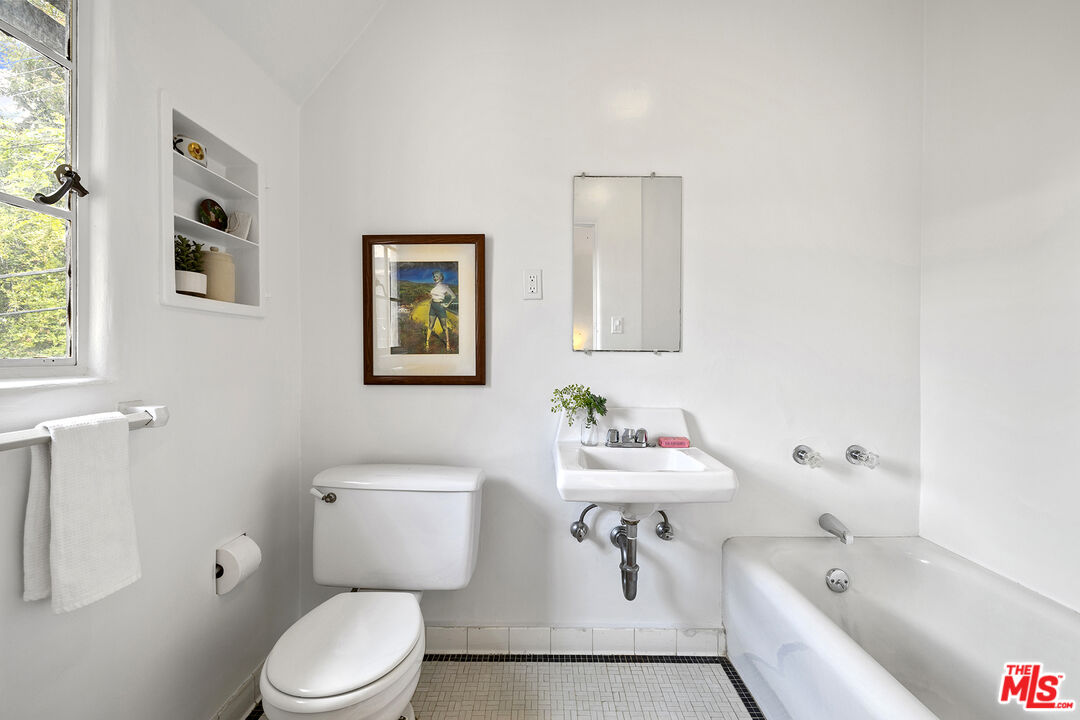 5473 Dahlia Drive Los Angeles, CA 90041 - Photo 31 of 34 a bathroom with a sink a toilet and a bathtub