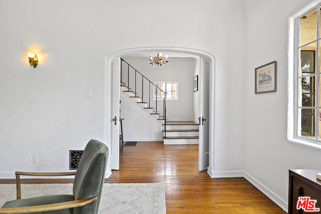 5473 Dahlia Drive Los Angeles, CA 90041 - Photo 4 of 34 a view of a hallway with wooden floor and dining room