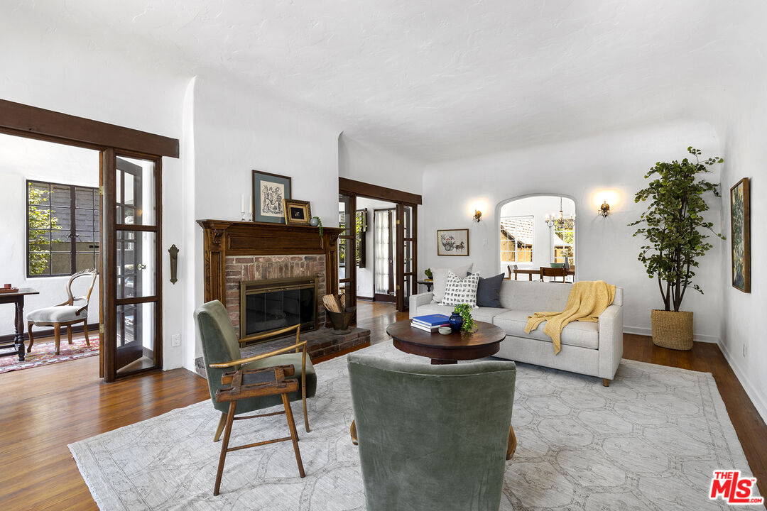 5473 Dahlia Drive Los Angeles, CA 90041 - Photo 5 of 34 a living room with furniture a fireplace a potted plant and a large window